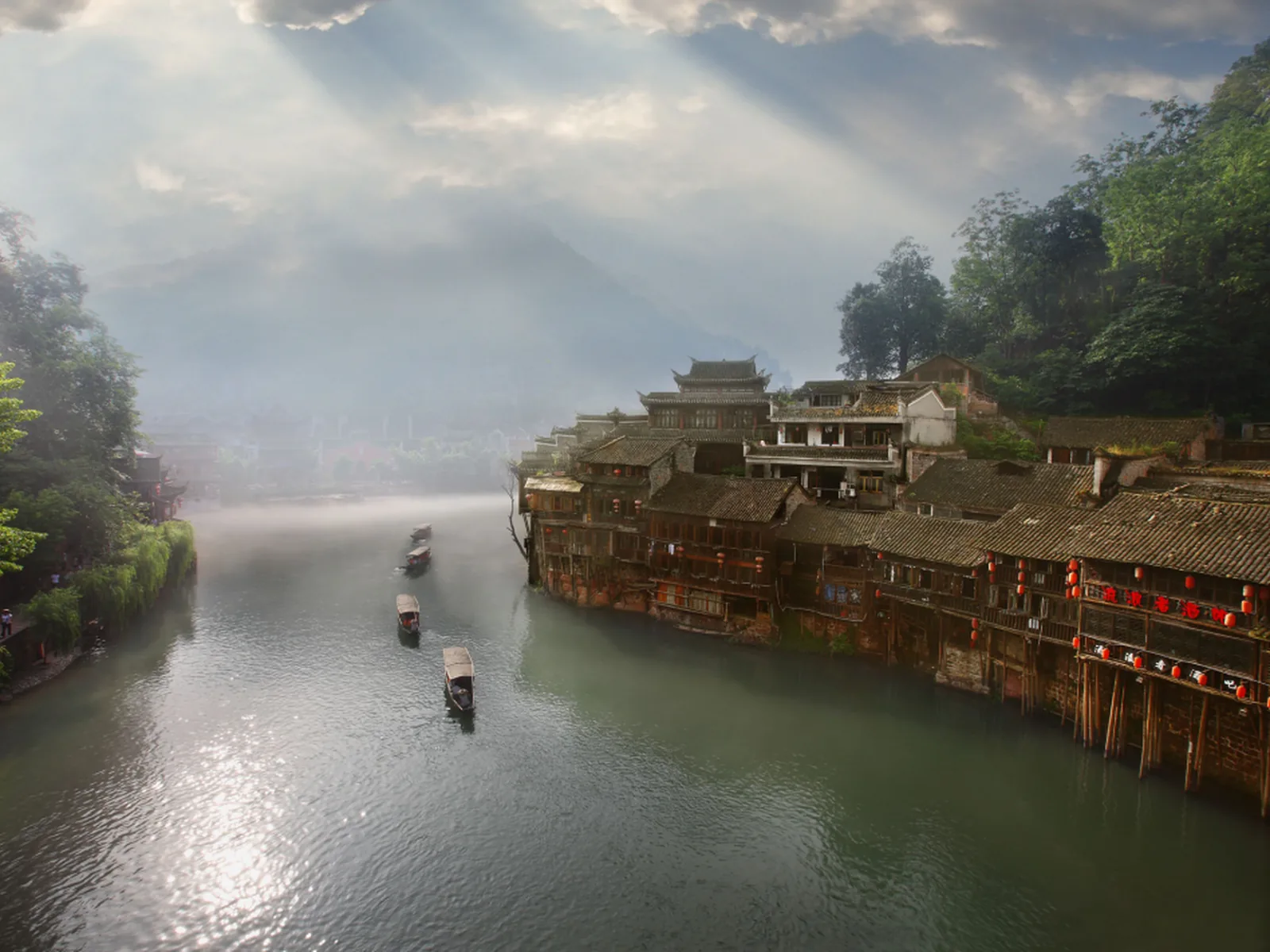 A misty riverside village in the Wuling Mountains