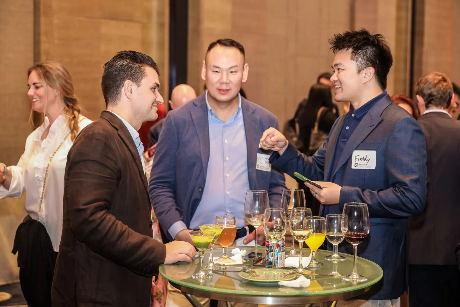 International guests connecting through conversation at a cultural gathering